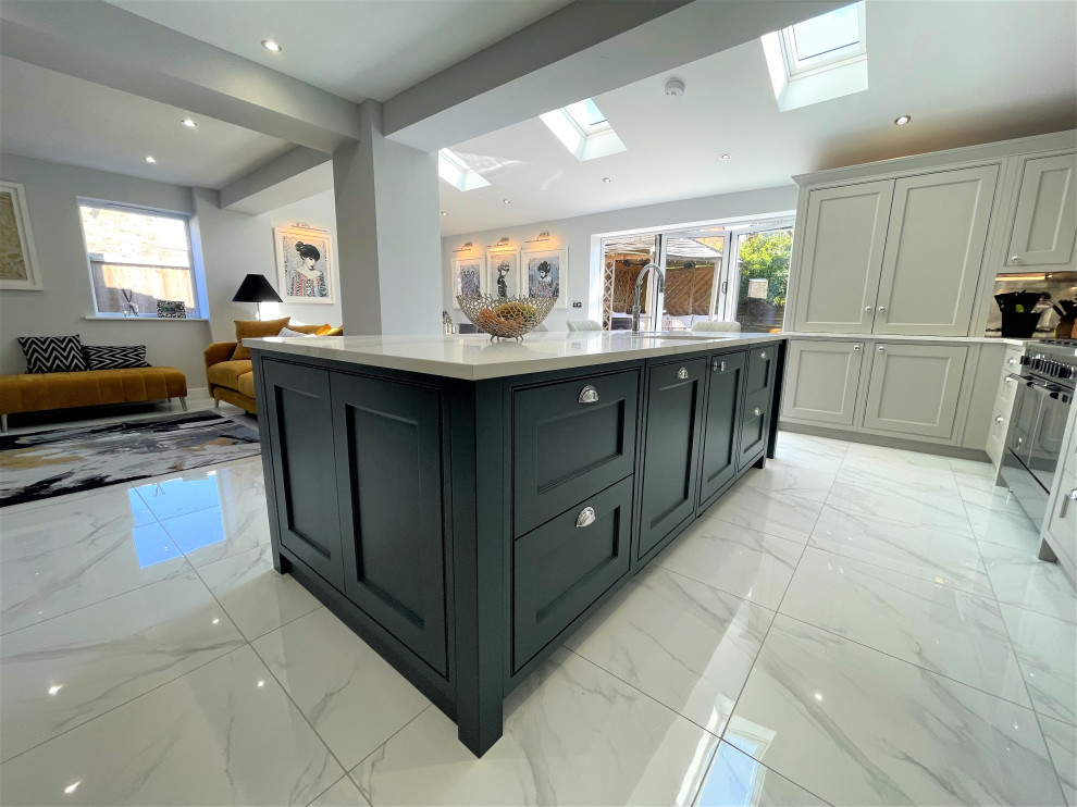 Inspiration for a mid-sized traditional l-shaped eat-in kitchen in Other with raised-panel cabinets, medium wood cabinets, quartz benchtops, glass sheet splashback, stainless steel appliances, porcelain floors and with island.