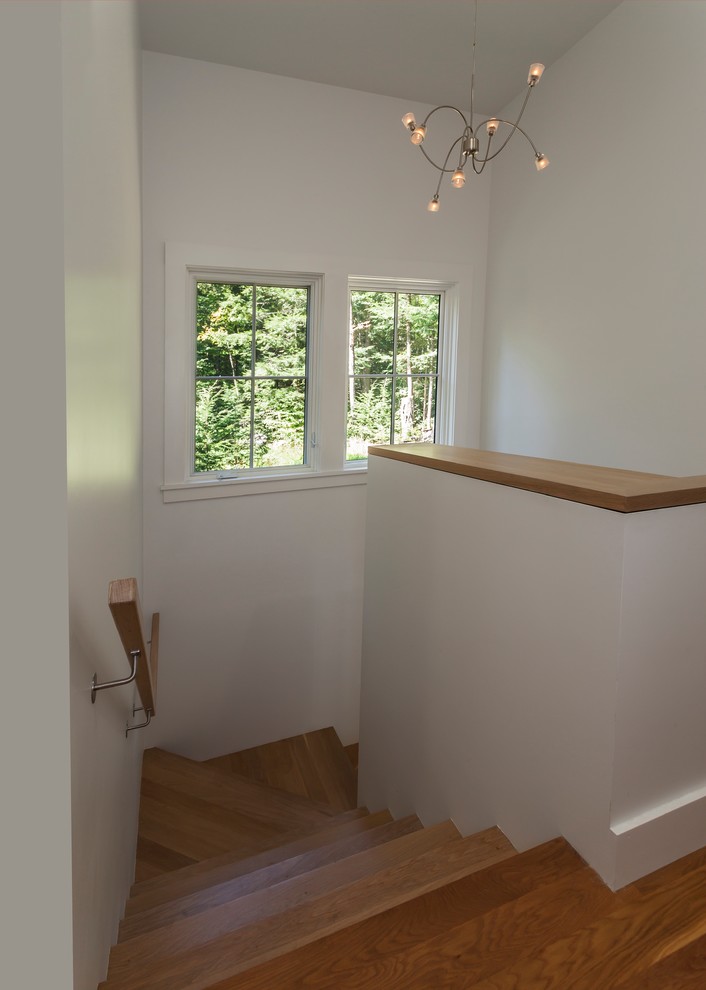 Inspiration for a contemporary wood u-shaped staircase in Manchester with wood risers.