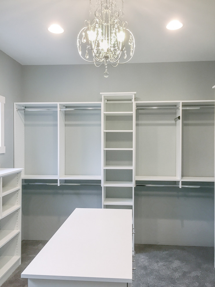 Inspiration for a large modern women's walk-in wardrobe in Other with open cabinets, white cabinets, carpet and grey floor.