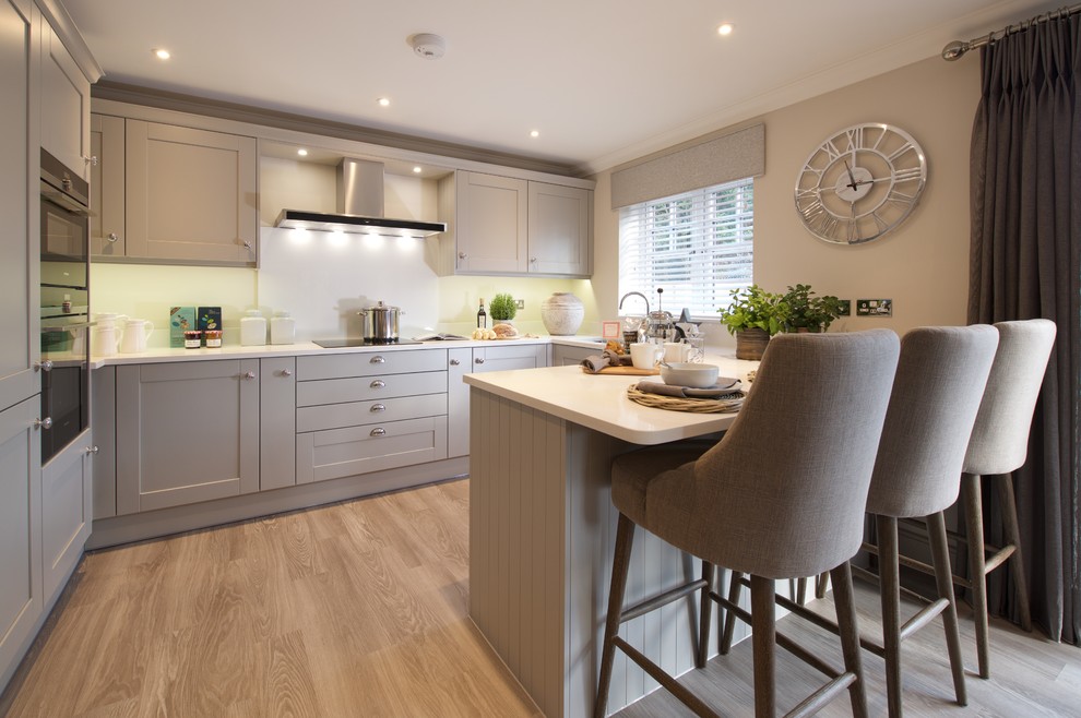 Inspiration for a transitional kitchen in London with medium hardwood floors and brown floor.