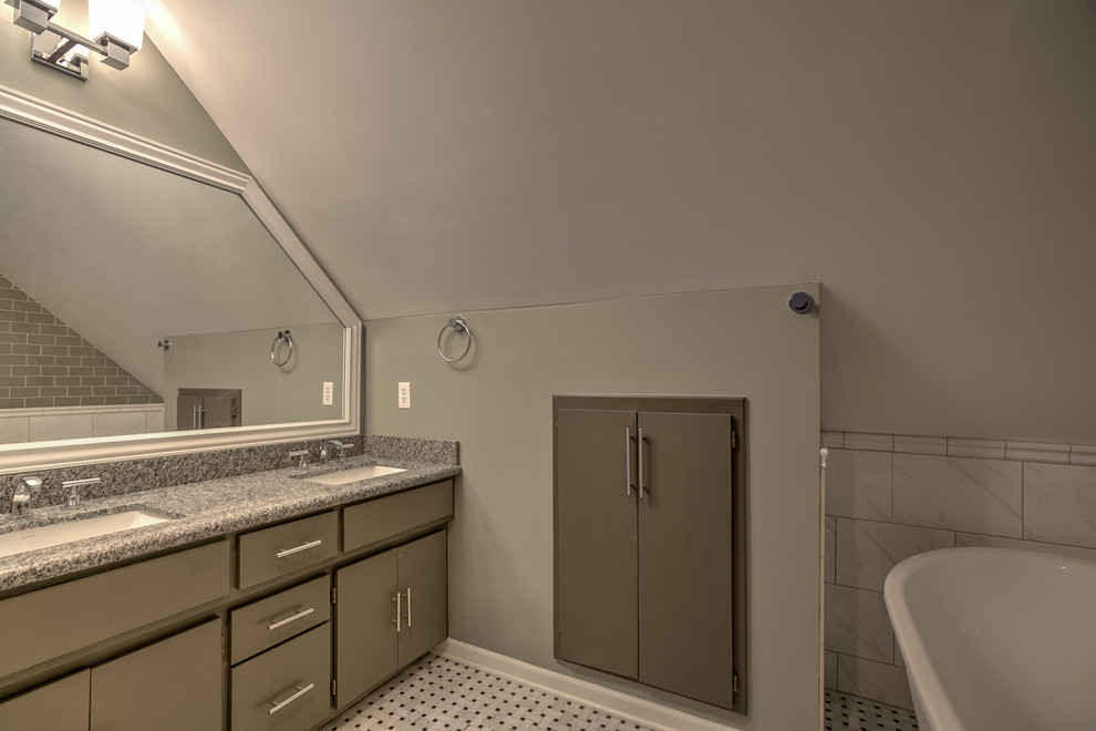 This is an example of a small transitional master bathroom in Omaha with an undermount sink, flat-panel cabinets, grey cabinets, a freestanding tub, a corner shower, a one-piece toilet, white tile, ceramic tile, grey walls and marble floors.