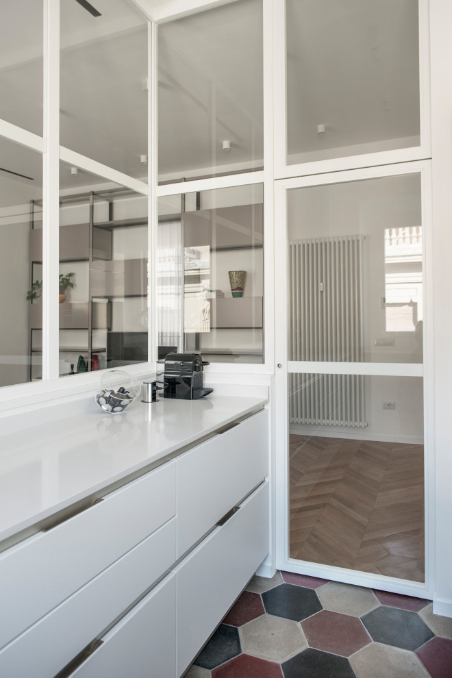 Mid-sized contemporary u-shaped separate kitchen in Rome with flat-panel cabinets, white cabinets and no island.