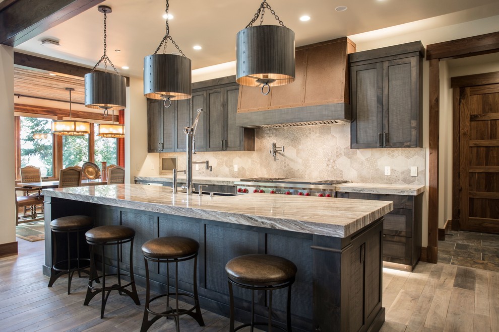 Country galley kitchen in Salt Lake City with a farmhouse sink, beaded inset cabinets, dark wood cabinets, grey splashback, stainless steel appliances, dark hardwood floors and brown floor.