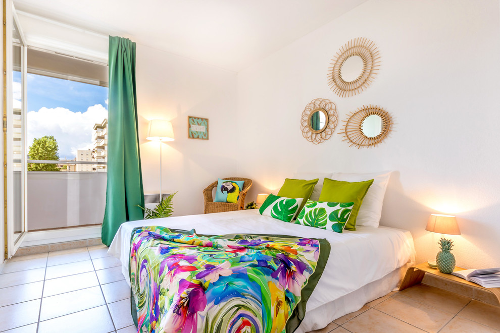 Foto de dormitorio principal tropical de tamaño medio con paredes blancas y suelo de baldosas de cerámica