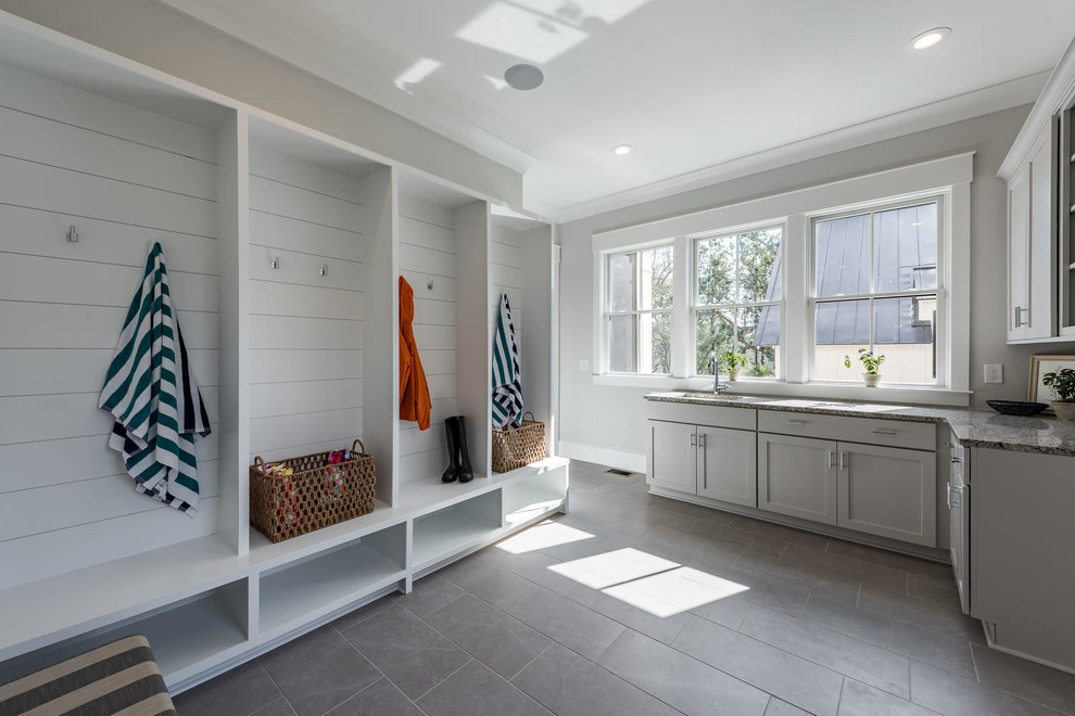 Photo of a transitional mudroom in Charleston with grey walls and grey floor.