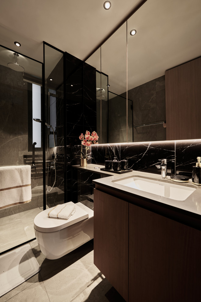 Inspiration for a mid-sized contemporary 3/4 bathroom in Singapore with flat-panel cabinets, brown cabinets, an alcove shower, a wall-mount toilet, black tile, an undermount sink, grey floor and grey benchtops.