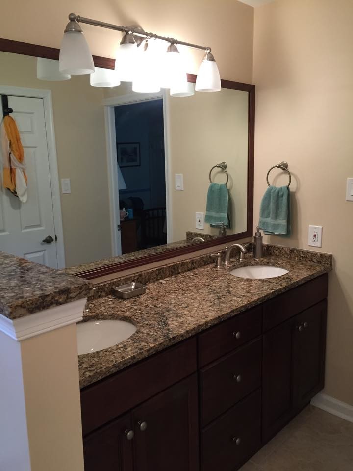 Design ideas for a mid-sized transitional 3/4 bathroom in Philadelphia with recessed-panel cabinets, dark wood cabinets, an alcove shower, beige tile, ceramic tile, beige walls, ceramic floors, an undermount sink, granite benchtops, beige floor and a hinged shower door.