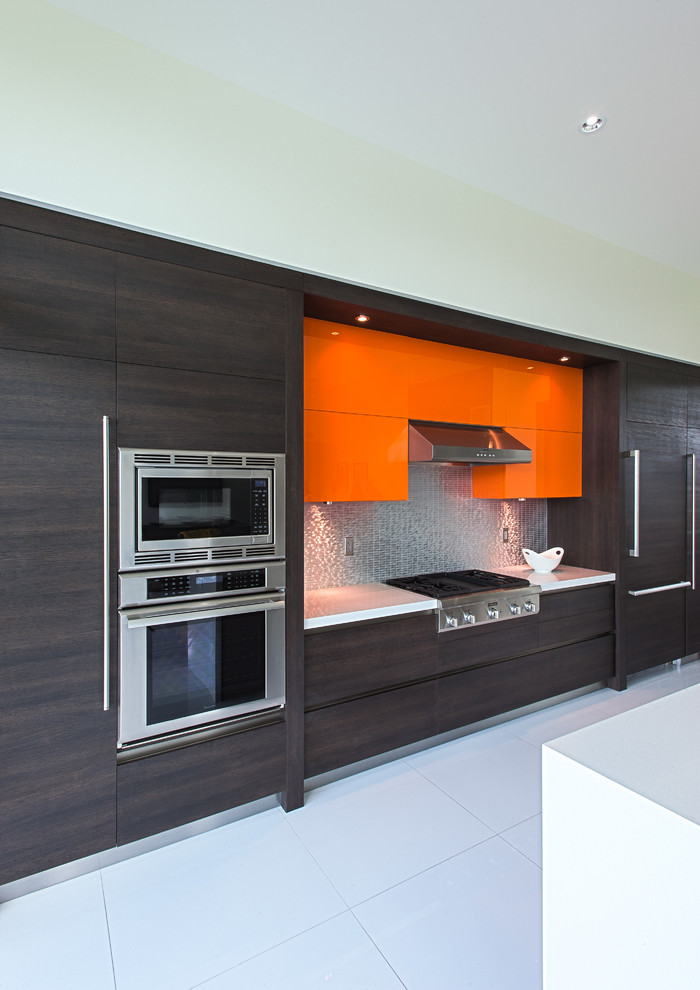 Design ideas for a large modern u-shaped eat-in kitchen in Miami with a double-bowl sink, flat-panel cabinets, dark wood cabinets, stainless steel benchtops, metallic splashback, metal splashback, stainless steel appliances, ceramic floors and with island.