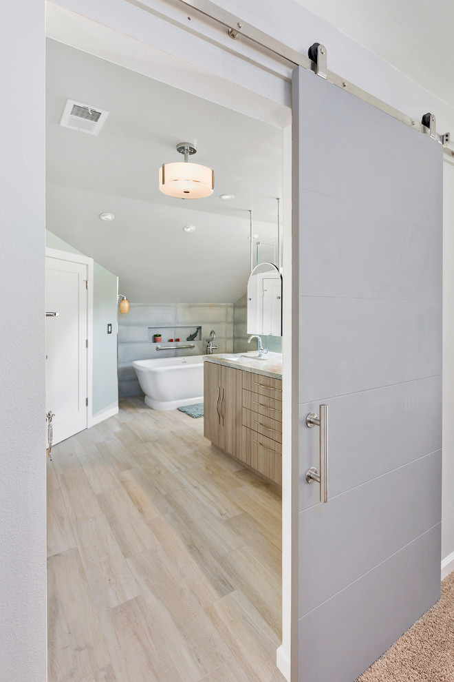 This is an example of a large beach style master bathroom in Tampa with flat-panel cabinets, distressed cabinets, a freestanding tub, an open shower, a one-piece toilet, green tile, porcelain tile, green walls, porcelain floors, an undermount sink, quartzite benchtops, brown floor, a hinged shower door and green benchtops.