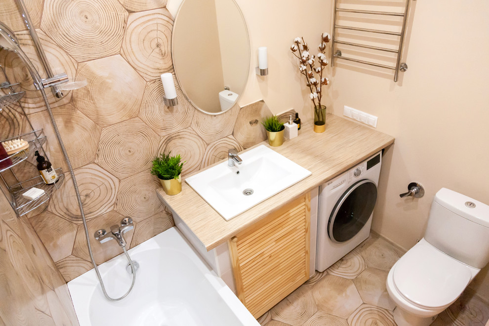 This is an example of a small scandinavian master bathroom in Moscow with louvered cabinets, medium wood cabinets, an undermount tub, a shower/bathtub combo, a one-piece toilet, brown tile, ceramic tile, beige walls, ceramic floors, an undermount sink, laminate benchtops, brown floor, a shower curtain and beige benchtops.