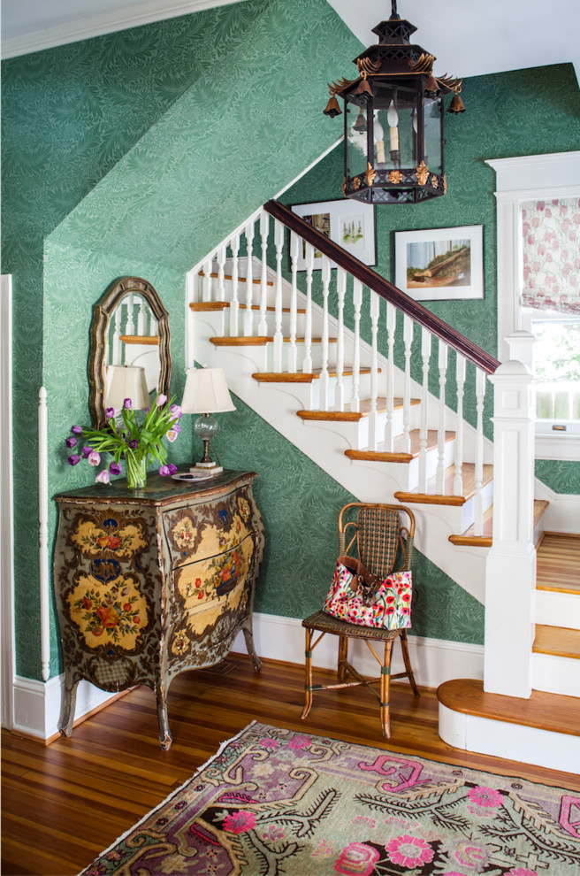 Design ideas for a traditional foyer in DC Metro with green walls, brown floor and dark hardwood floors.