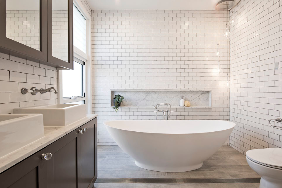 Inspiration for a large beach style master bathroom in Sydney with recessed-panel cabinets, grey cabinets, a freestanding tub, a one-piece toilet, white tile, subway tile, white walls, ceramic floors, an integrated sink, terrazzo benchtops and brown floor.