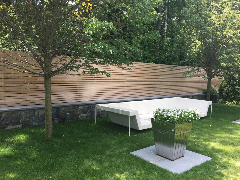 Inspiration for a huge modern backyard concrete patio fountain remodel in New York