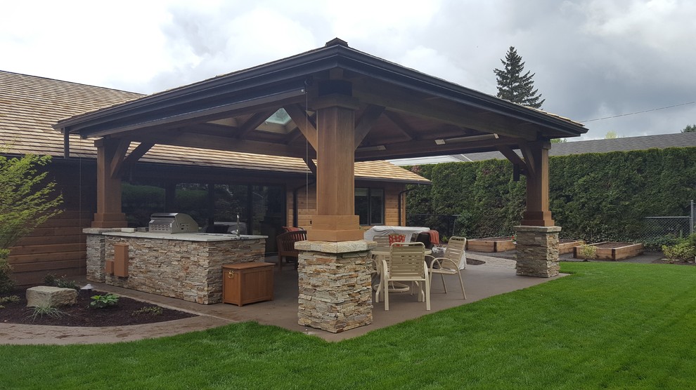 Design ideas for an arts and crafts backyard verandah in Portland with an outdoor kitchen, concrete slab and a pergola.