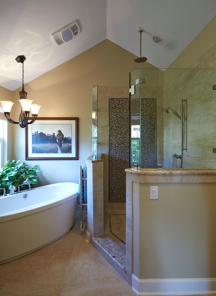 Inspiration for a mid-sized traditional master bathroom in Jacksonville with a drop-in sink, raised-panel cabinets, medium wood cabinets, granite benchtops, a freestanding tub, a corner shower, beige tile, porcelain tile, beige walls and porcelain floors.