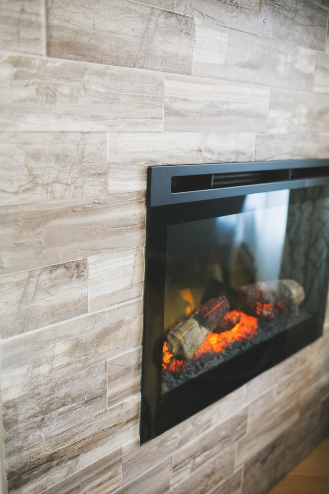 Home design - mid-sized transitional formal and enclosed light wood floor home design idea with beige walls, a corner fireplace, a tile fireplace and no tv