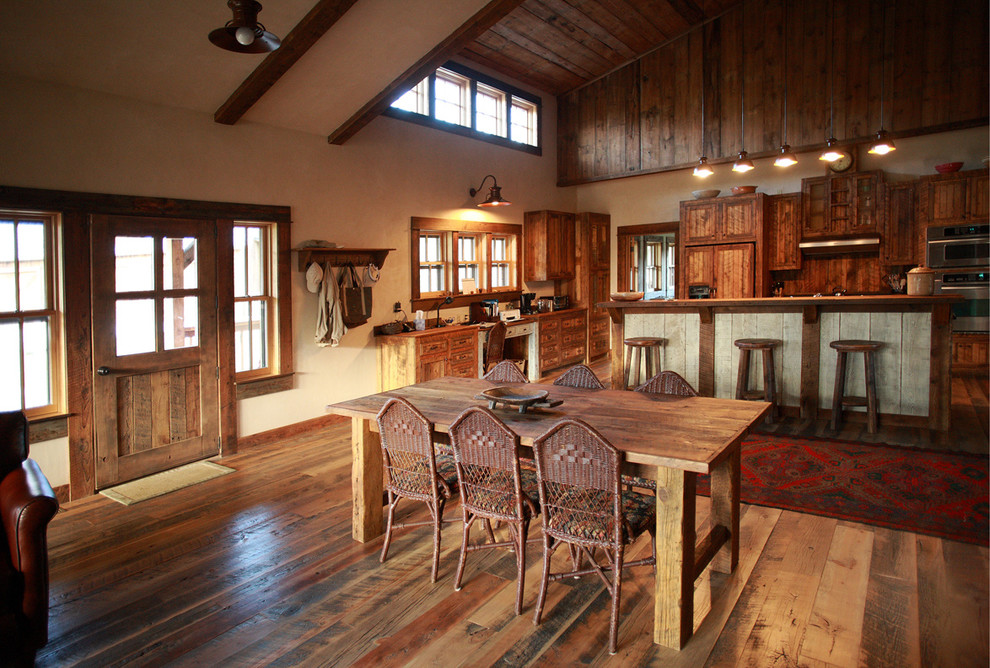 Kitchen/dining room combo - rustic medium tone wood floor kitchen/dining room combo idea with multicolored walls