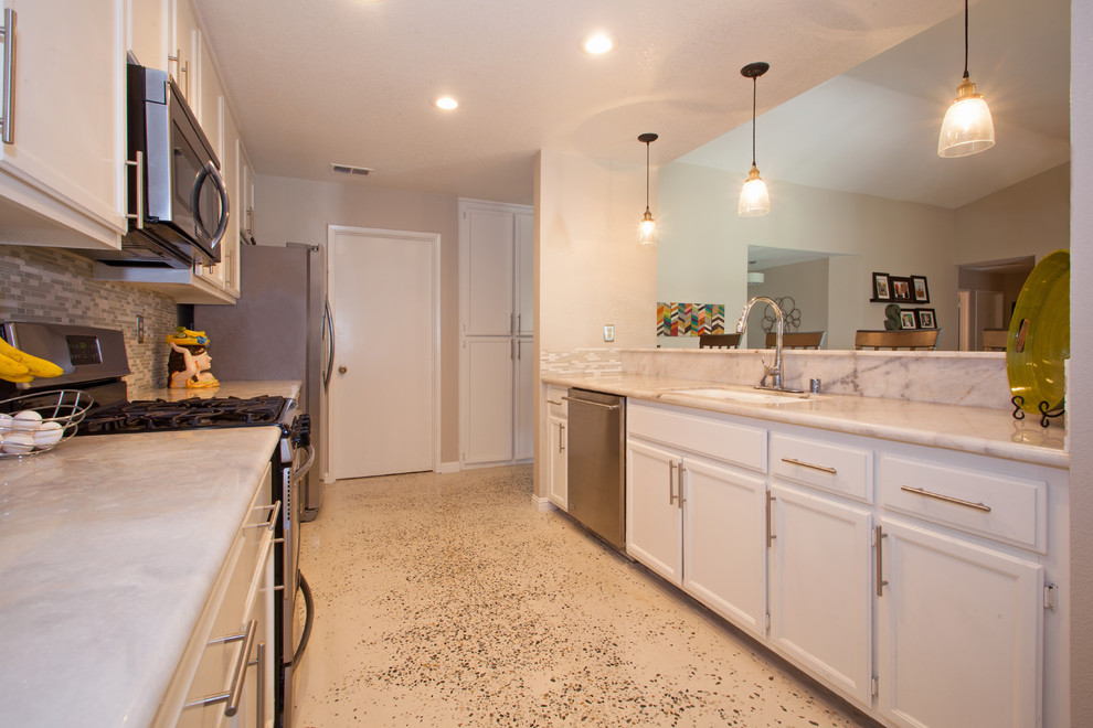 Mid-sized transitional kitchen photo in Sacramento with flat-panel cabinets, white cabinets, granite countertops and glass tile backsplash