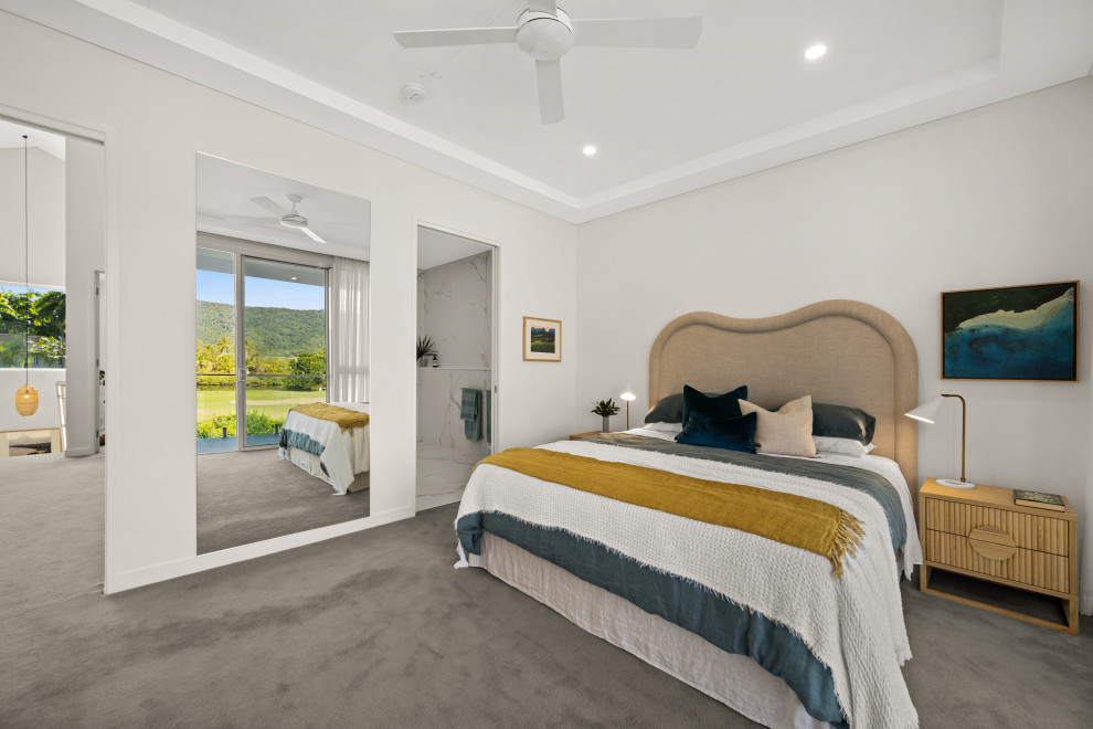 This is an example of a contemporary master bedroom in Other with carpet.