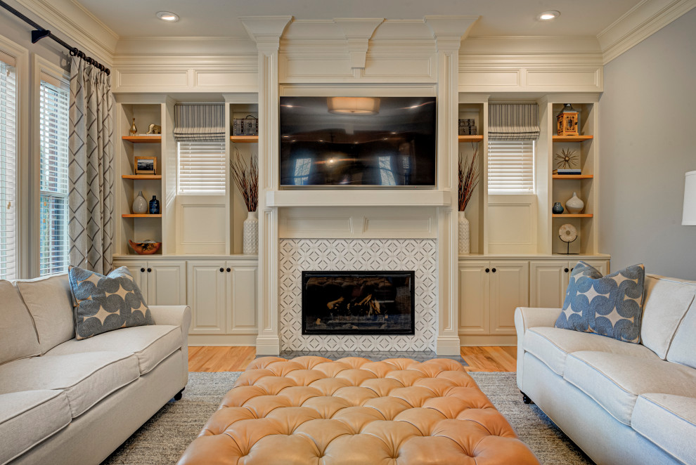 Example of a mid-sized transitional formal and enclosed medium tone wood floor and beige floor living room design in Indianapolis with a standard fireplace, a wall-mounted tv, a tile fireplace and gray walls