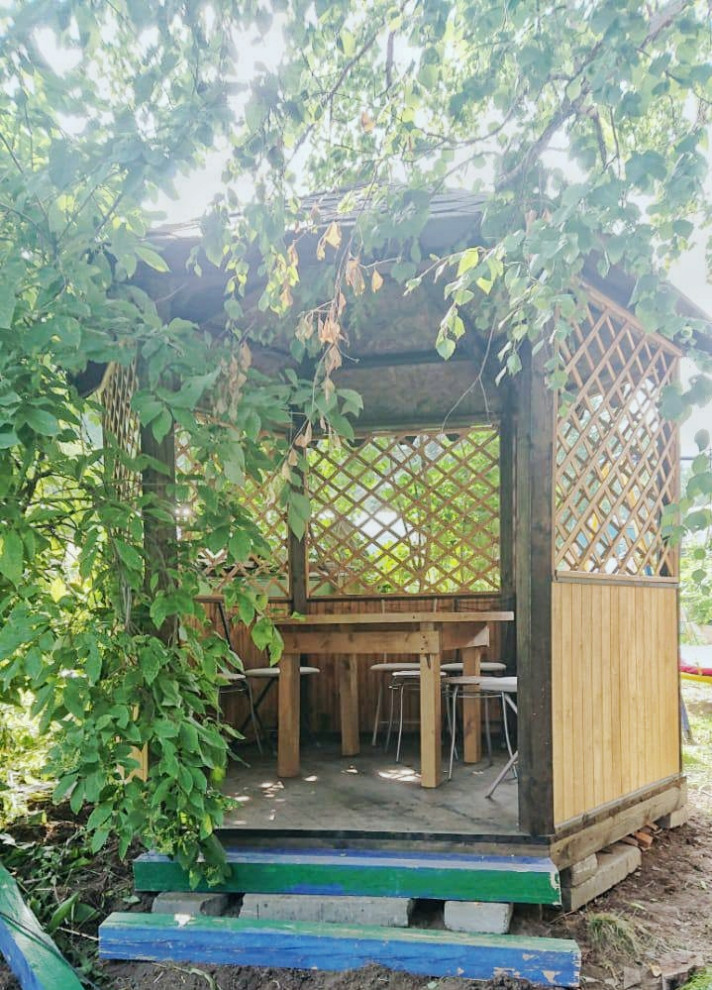 Photo of a small contemporary partial sun courtyard landscaping in Other with a pergola for summer.