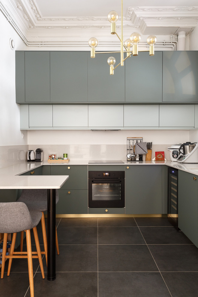Photo of a large grey and white u-shaped kitchen/diner in Paris with a submerged sink, beaded cabinets, green cabinets, quartz worktops, white splashback, stone slab splashback, black appliances, ceramic flooring, a breakfast bar, grey floors and white worktops.