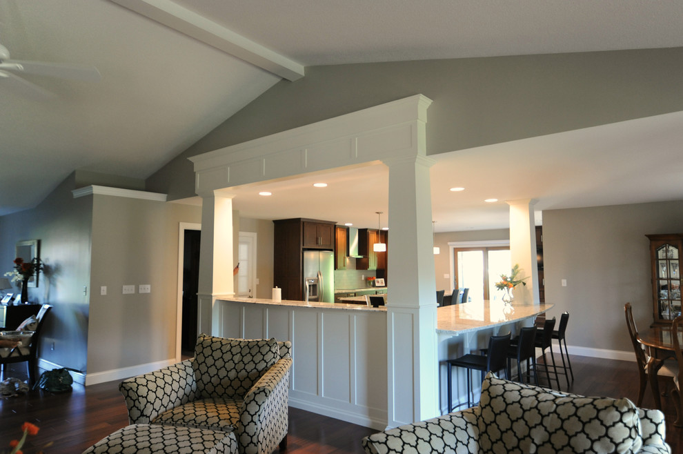 Open concept kitchen - huge transitional l-shaped ceramic tile open concept kitchen idea in Chicago with an undermount sink, shaker cabinets, medium tone wood cabinets, granite countertops, gray backsplash, glass tile backsplash, stainless steel appliances and an island