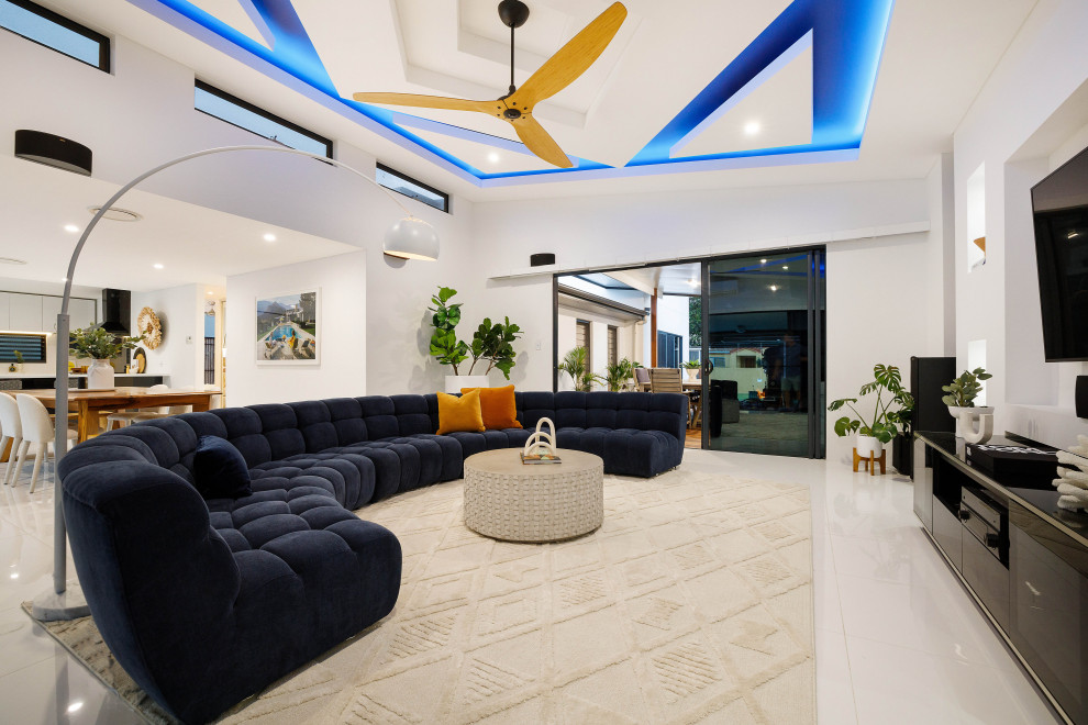 Large modern open plan games room in Gold Coast - Tweed with white walls, ceramic flooring, a built-in media unit, white floors and a vaulted ceiling.