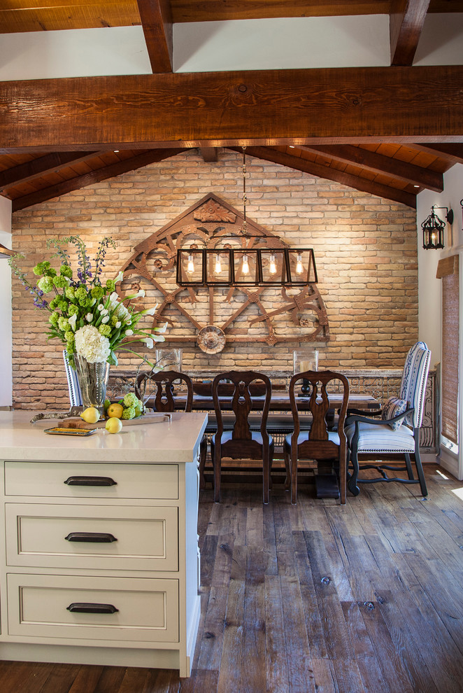 Inspiration for a mid-sized country kitchen/dining combo in San Francisco with white walls, dark hardwood floors, no fireplace and brown floor.