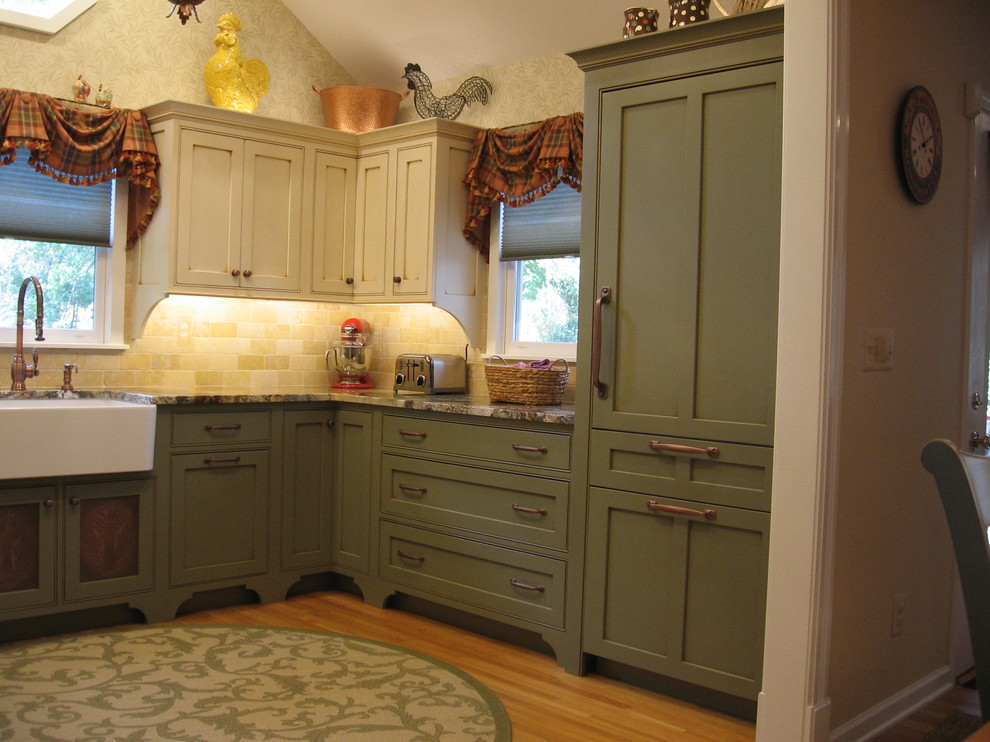 Photo of a mid-sized country u-shaped separate kitchen in Philadelphia with a farmhouse sink, shaker cabinets, green cabinets, granite benchtops, beige splashback, stone tile splashback, stainless steel appliances, medium hardwood floors and no island.