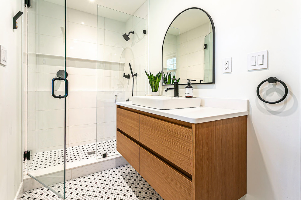 Inspiration for a mid-sized midcentury master bathroom in Richmond with flat-panel cabinets, medium wood cabinets, an alcove shower, a one-piece toilet, white tile, ceramic tile, white walls, ceramic floors, a vessel sink, granite benchtops, multi-coloured floor, a hinged shower door, white benchtops, a niche, a single vanity and a floating vanity.