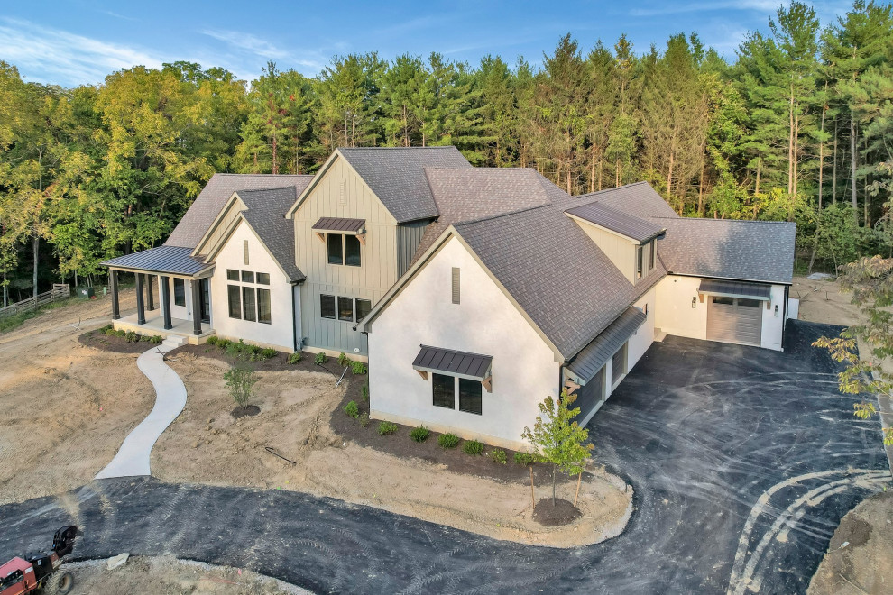 Example of a large transitional attached four-car garage design in Columbus