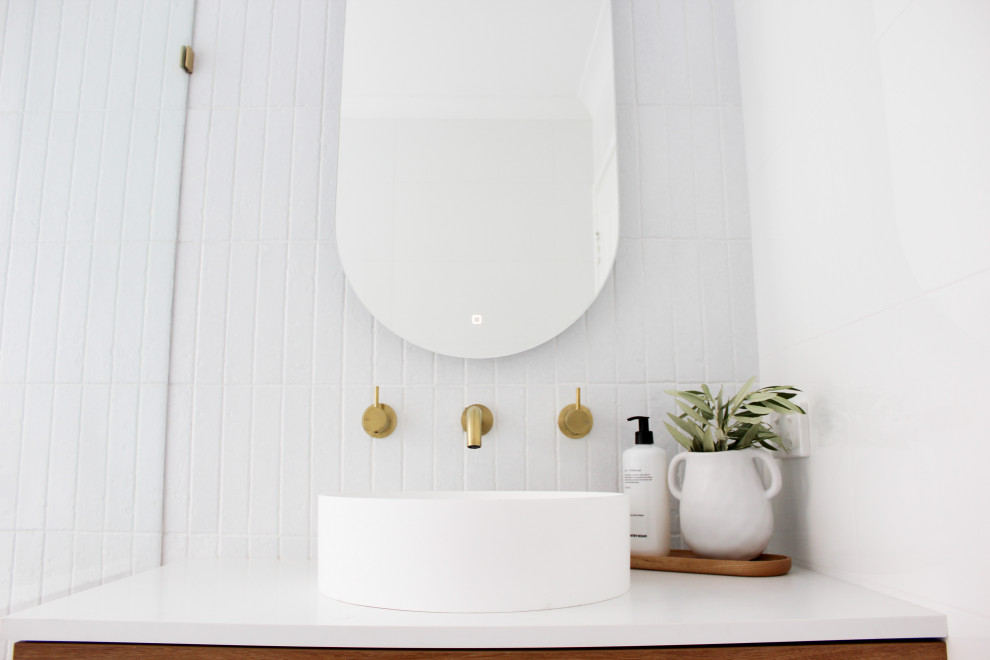 Inspiration for a mid-sized modern kids wet room bathroom in Perth with flat-panel cabinets, dark wood cabinets, a freestanding tub, white tile, ceramic tile, white walls, porcelain floors, a vessel sink, engineered quartz benchtops, white floor, an open shower and white benchtops.