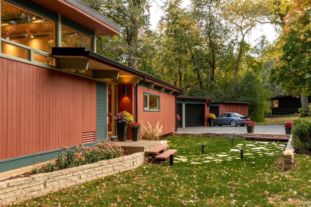 Design ideas for a mid-sized midcentury split-level multi-coloured house exterior in Minneapolis with wood siding and a flat roof.