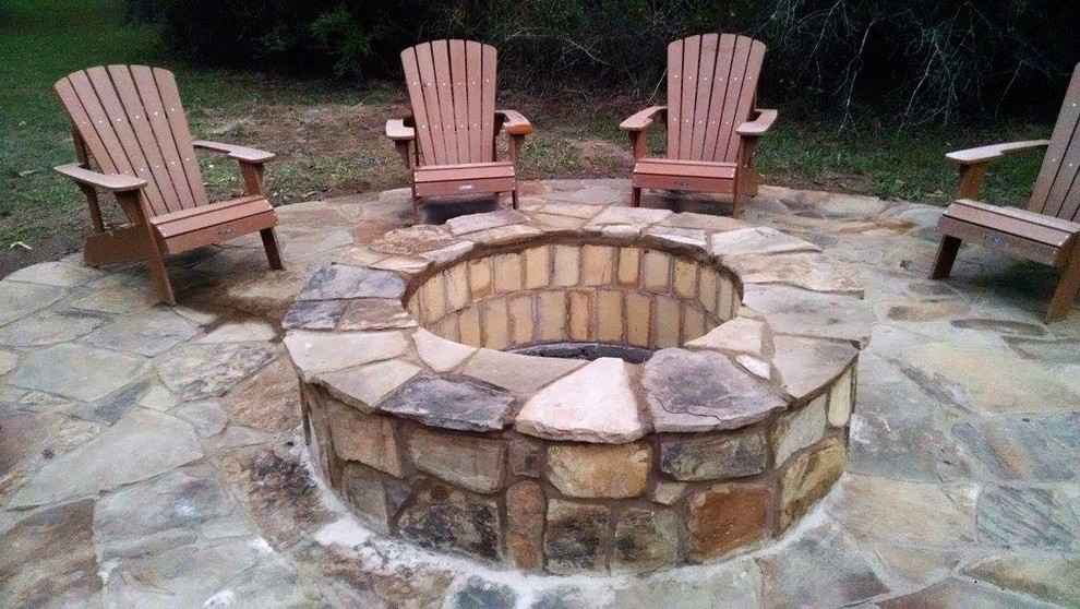 Patio - mid-sized rustic backyard stone patio idea in Houston with a fire pit and no cover