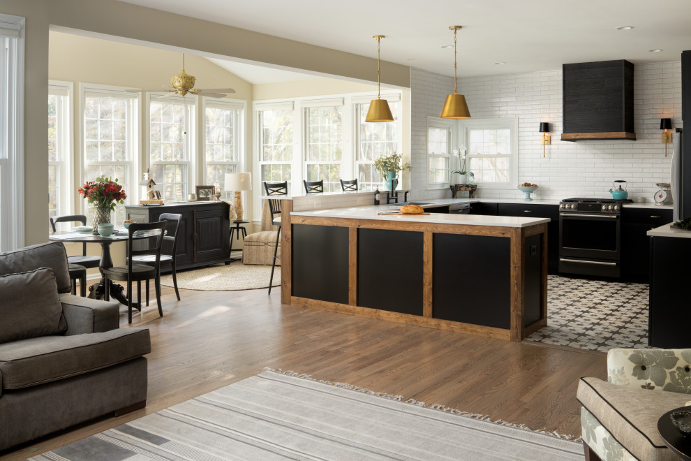 Photo of a large contemporary u-shaped open plan kitchen in DC Metro with shaker cabinets, black cabinets, white splashback, black appliances, a peninsula, multi-coloured floor, white benchtop, a drop-in sink, quartz benchtops, porcelain splashback and porcelain floors.