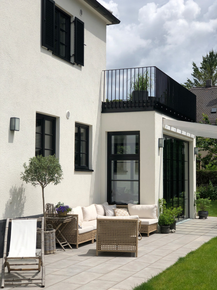 Photo of a medium sized traditional metal railing terrace in Munich with a pergola.