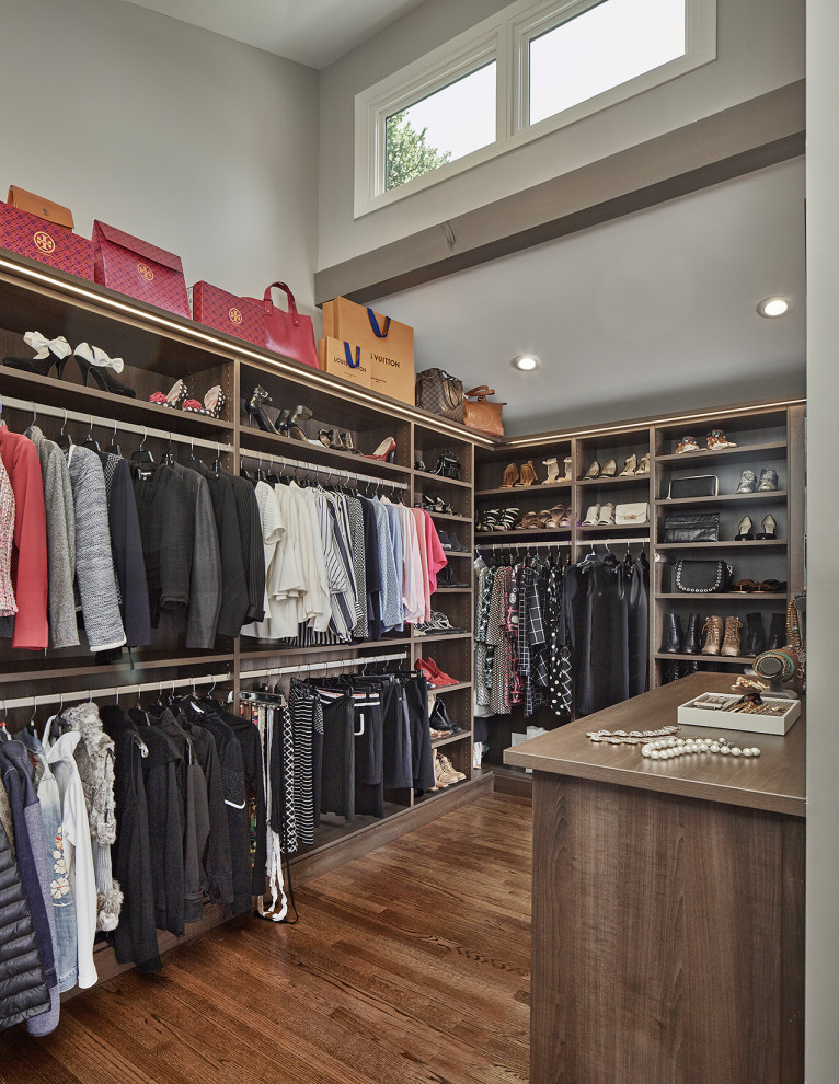 Design ideas for a modern storage and wardrobe in Dallas with medium wood cabinets and medium hardwood floors.