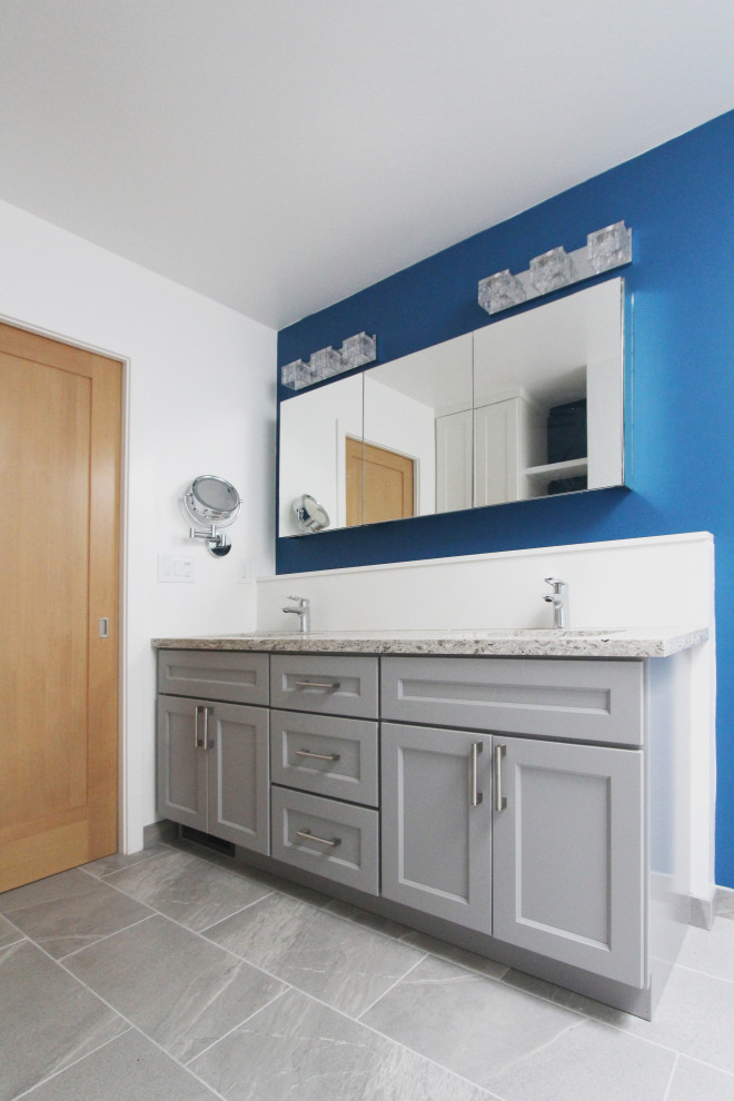 Inspiration for a mid-sized transitional master white tile and porcelain tile porcelain tile, gray floor and double-sink walk-in shower remodel with shaker cabinets, gray cabinets, a two-piece toilet, blue walls, an undermount sink, quartz countertops, multicolored countertops, a niche and a built-in vanity