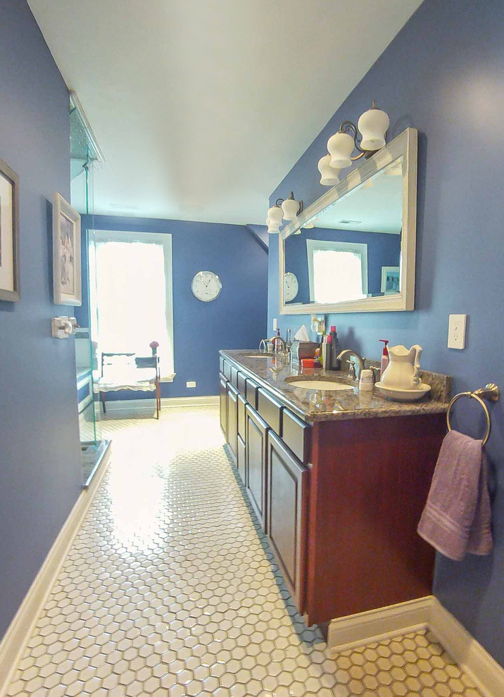 This is an example of a large traditional master bathroom in Chicago with raised-panel cabinets, dark wood cabinets, a two-piece toilet, white tile, blue walls, mosaic tile floors, a drop-in sink, marble benchtops, white floor, a hot tub, a corner shower, mosaic tile, a hinged shower door, brown benchtops, a double vanity, a floating vanity, exposed beam and wallpaper.