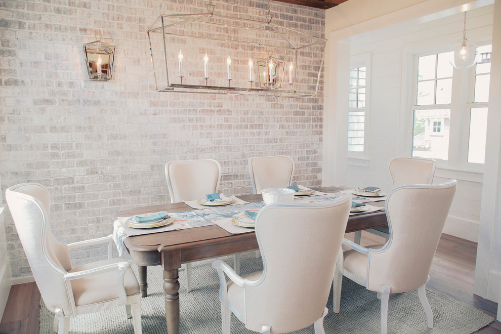 Inspiration for a beach style separate dining room in Miami with white walls, medium hardwood floors and brown floor.