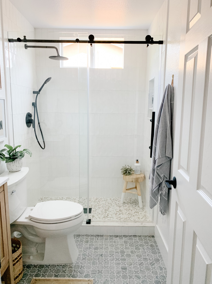 Design ideas for a small traditional bathroom in San Diego with beige cabinets, an alcove shower, white tiles, ceramic tiles, white walls, marble flooring, a submerged sink, engineered stone worktops, grey floors, a sliding door, white worktops, a single sink and a freestanding vanity unit.