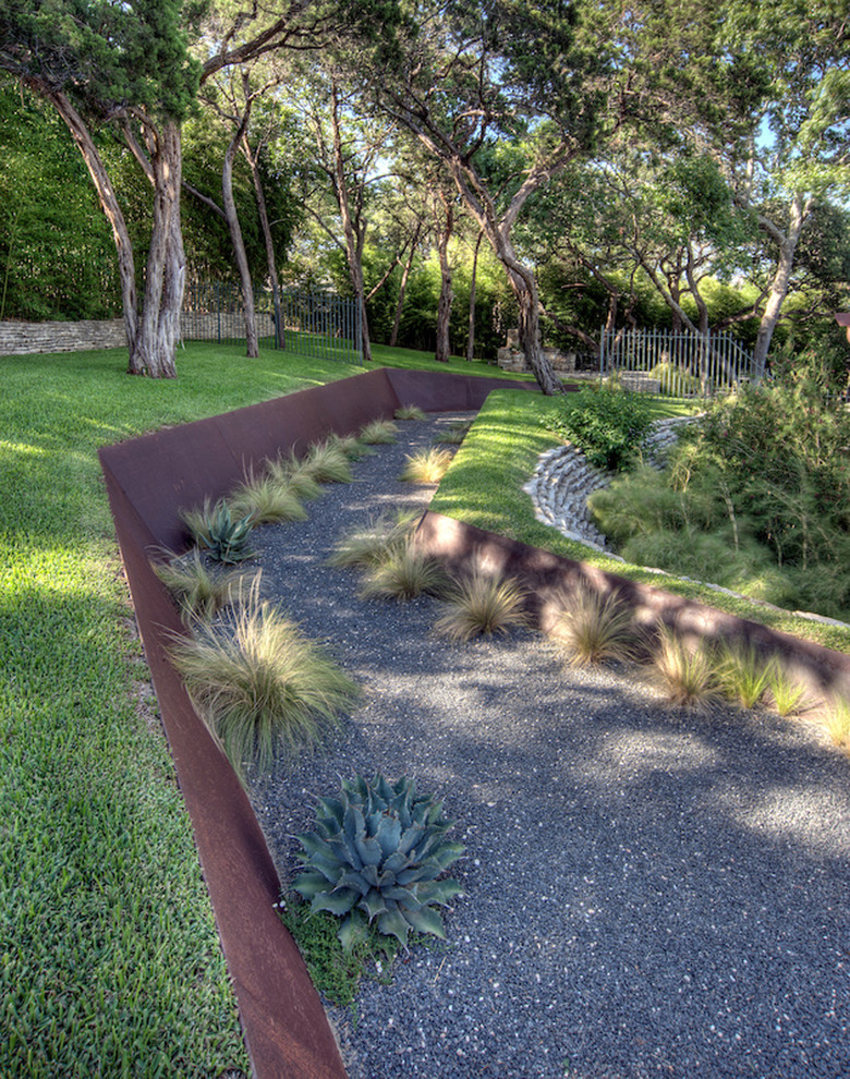 This is an example of an industrial garden in Austin with a retaining wall.