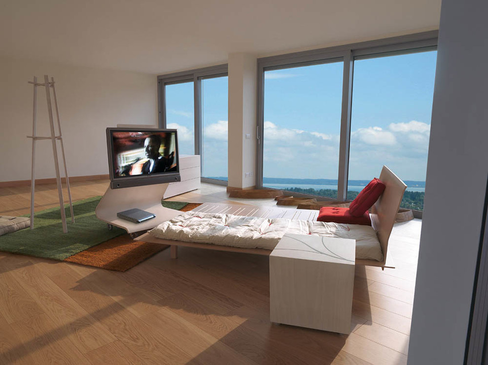 Inspiration for a large contemporary loft-style bedroom in Miami with plywood floors and beige walls.