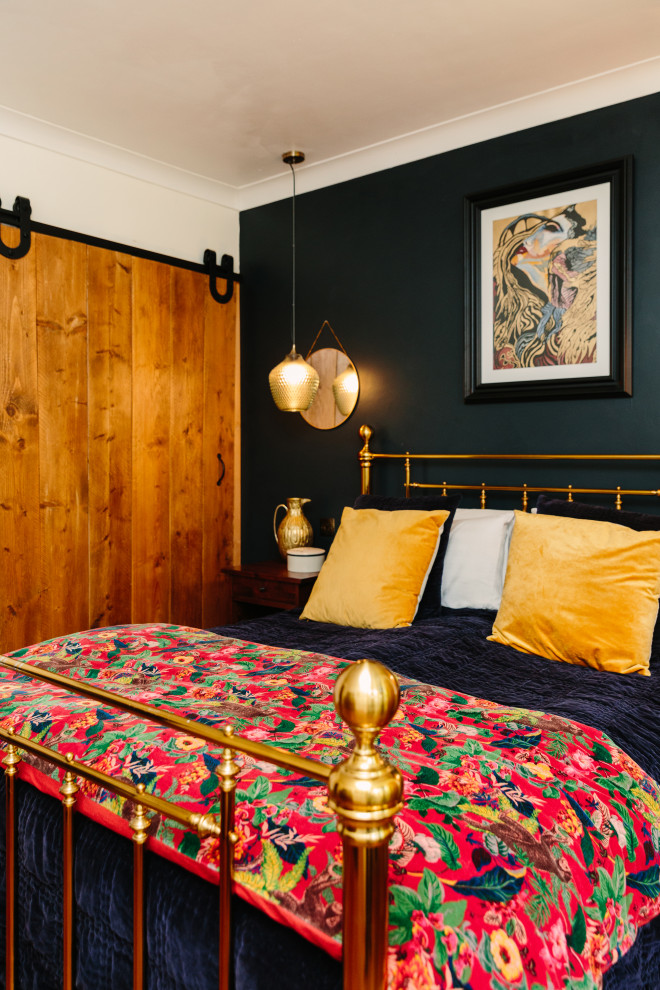 Eclectic bedroom in London with black walls.