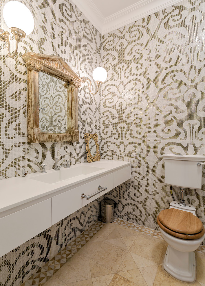 Photo of a traditional powder room in Moscow with flat-panel cabinets, white cabinets, a two-piece toilet, beige tile, white tile, multi-coloured tile, mosaic tile, an integrated sink and beige floor.