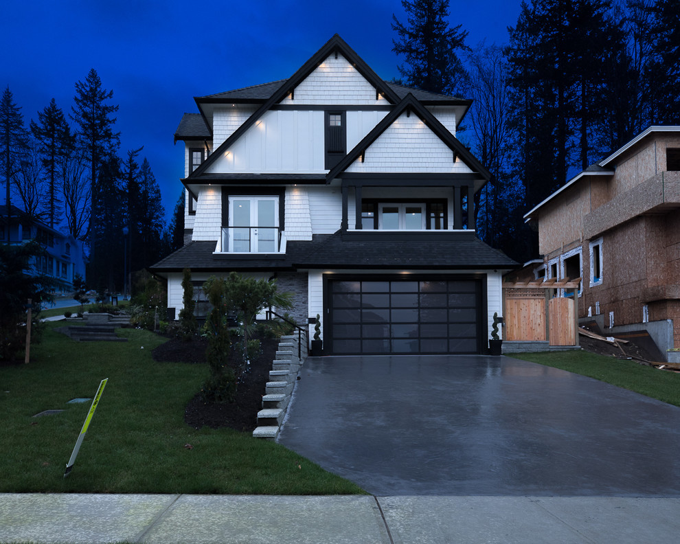 Large contemporary two-storey white house exterior in Vancouver with mixed siding, a gable roof and a shingle roof.