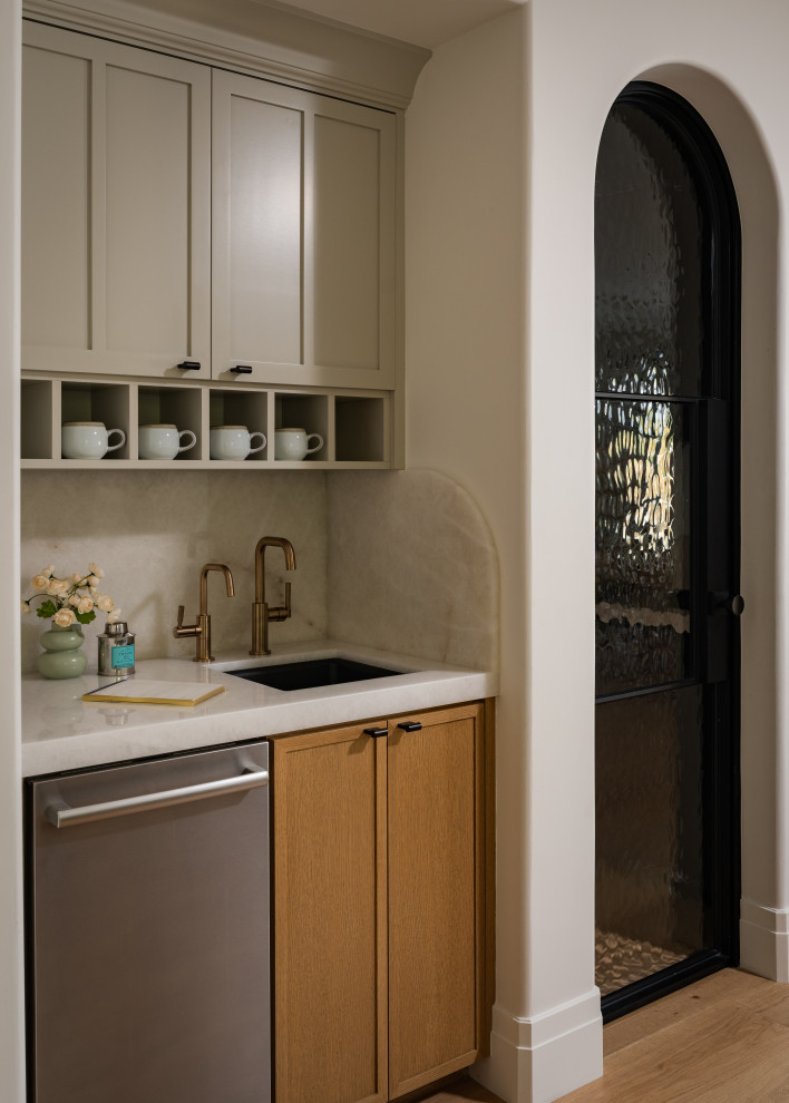 Kitchen - transitional light wood floor kitchen idea in Orange County with recessed-panel cabinets and stainless steel appliances