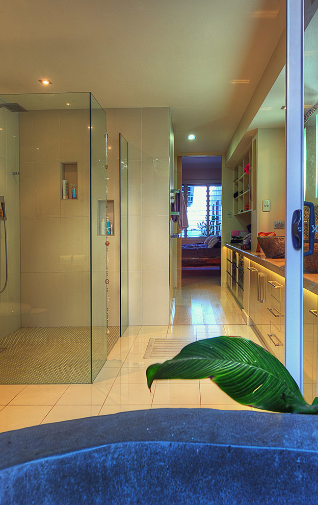 Tropical master bathroom in Cairns with a freestanding tub.