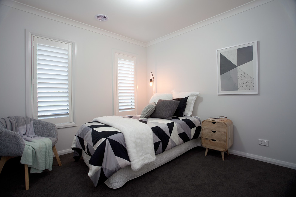 This is an example of a mid-sized modern guest bedroom in Melbourne with grey walls and carpet.